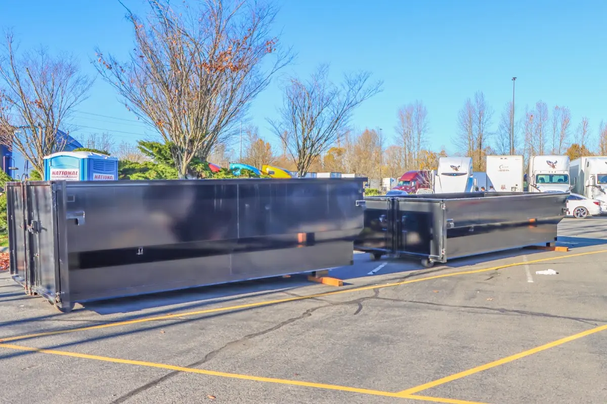 Professional dumpster rental service with roll-off container on residential driveway in Sumner